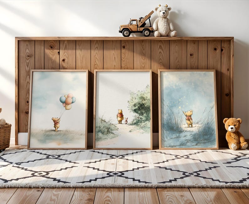 May include: Three framed watercolor prints featuring Winnie the Pooh. One shows Pooh with balloons, another walking with Piglet, and the last with a wand. A wooden shelf holds a toy truck, teddy bear, and stuffed bear.