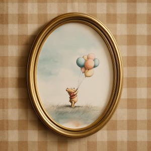 May include: An oval, gold-framed print featuring a watercolor illustration of a bear holding a bunch of pastel-colored balloons. The bear is standing in a grassy field under a light blue sky. The frame is a warm gold color.