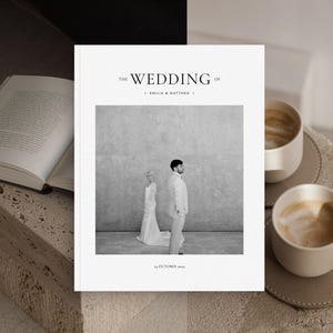Könnte beinhalten: Ein Hochzeitsalbum mit dem Titel "The Wedding of Emilia & Matthew" mit einem Schwarz-Weiß-Foto von Braut und Bräutigam. Zwei Tassen Kaffee stehen auf einer Steinoberfläche neben einem offenen Buch.