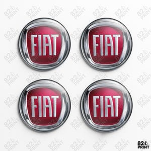 May include: Four circular Fiat car emblems. Each emblem has the Fiat logo in white text on a red background, within a silver-coloured, rounded border. The background is white.