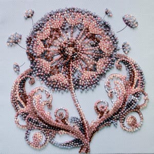 May include: A detailed, beaded artwork depicting a dandelion. The piece features a large, round seed head in shades of pink, brown, and gray, with delicate stems and leaves. The background is a light blue.