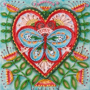 May include: A detailed beaded artwork depicting a red heart with a blue butterfly and the word "LOVE". The heart is surrounded by flowers and green leaves, set against a turquoise backdrop. The piece uses a variety of colours and textures.