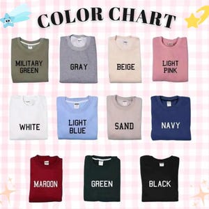 May include: A color chart featuring eleven crewneck sweatshirts in various colors including military green, gray, beige, light pink, white, light blue, sand, navy, maroon, green, and black, each labeled with its corresponding color name in black text.