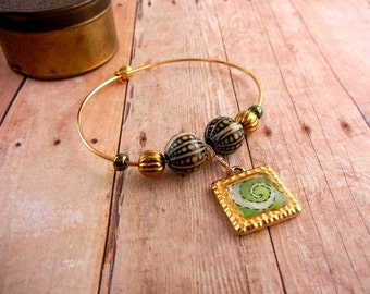 Gold bangle bracelet with green spiral in picture frame charm with mood beads // spiral jewelry /