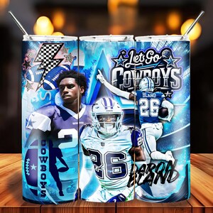 May include: A set of three stainless steel tumblers featuring a blue and white design with Dallas Cowboys football players and the text "Let Go Cowboys" and "Aaron Bland". Each tumbler has a silver straw.
