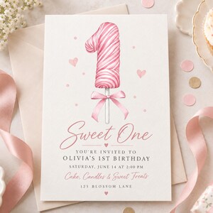 May include: A rectangular birthday invitation card featuring a pink and white swirled number one lollipop illustration with a pink ribbon bow. The text reads: Sweet One, You're invited to Olivia's 1st Birthday, Saturday, June 14 at 2:00 PM, Cake, Candles & Sweet Treats, 123 Blossom Lane.
