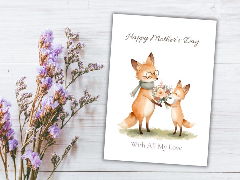May include: A Mother's Day card featuring watercolor illustrations of two foxes. One fox wears glasses and a scarf, holding flowers. The card reads "Happy Mother's Day" and "With All My Love" on a white background.