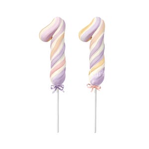 May include: Two number one shaped cake toppers featuring a swirled pattern of pastel purple, peach, and cream colors. Each topper is mounted on a thin white stick and decorated with a small satin ribbon bow tied at the base of the number.