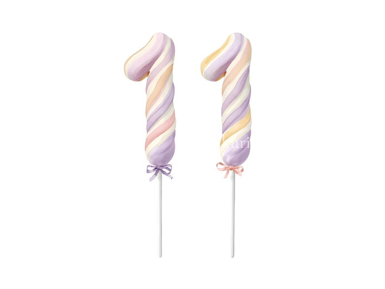 May include: Two number one shaped cake toppers featuring a swirled pattern of pastel purple, peach, and cream colors. Each topper is mounted on a thin white stick and decorated with a small satin ribbon bow tied at the base of the number.