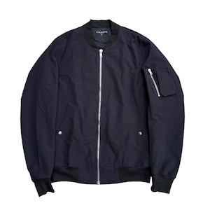 May include: A black bomber jacket with a silver zipper closure and a small zippered pocket on the left sleeve. The jacket has a ribbed collar, cuffs, and hem. The brand name is printed on the collar.