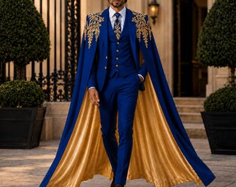May include: A royal blue three-piece suit featuring a matching cape with gold embroidery on the shoulders. The ensemble includes a waistcoat with gold buttons, a white dress shirt, a patterned tie, and trousers, with the cape lined in gold fabric.