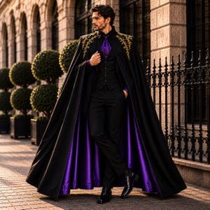 May include: A black floor-length cape with gold embroidery on the shoulders and a vibrant purple lining. The cape is worn over a black suit consisting of a vest, trousers, and a purple shirt with a matching purple necktie and black dress shoes.