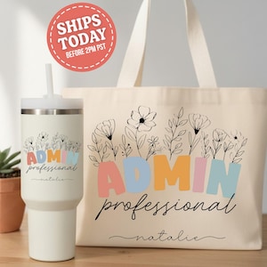 May include: A cream-colored tumbler and tote bag set. The tumbler has a white straw and the tote bag has handles. Both items feature the words "ADMIN professional" in colorful letters, floral designs, and the name "natalie".