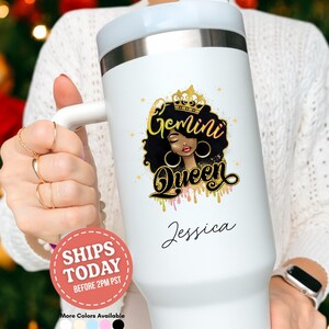 May include: White tumbler with a handle, featuring a "Gemini Queen" design with a black-haired woman wearing a gold crown and hoop earrings. The name "Jessica" is written below the design in cursive.