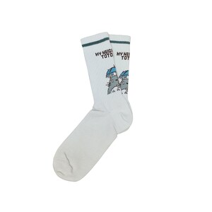 May include: A pair of white socks with a green stripe at the top and the text "MY NEIGHBOR TOTORO". The socks feature a cartoon illustration of Totoro characters holding umbrellas.