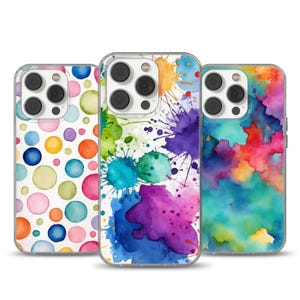 May include: Three clear phone cases with colorful designs. One case features a pattern of large, watercolor polka dots in various colors. Another has vibrant paint splatters in blue, purple, and orange. The third case displays a watercolor wash of red, blue, and yellow.