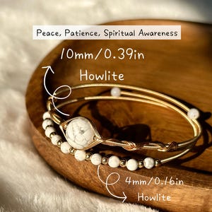 May include: Two gold-coloured bracelets with white howlite beads and accents. One bracelet features a larger howlite stone. Text reads "Peace, Patience, Spiritual Awareness" and measurements of 10mm/0.39in and 4mm/0.16in.
