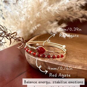 May include: Two gold-toned bracelets with red agate beads. One bracelet features a 10mm (0.39in) red agate stone, and the other has 4mm (0.16in) red agate beads. The image includes text about balancing energy and promoting blood circulation.