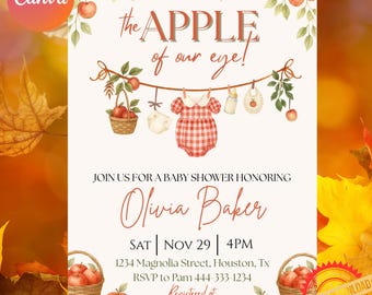 May include: A baby shower invitation featuring watercolor apples and a clothesline with a basket, diaper, red gingham romper, bottle, and bib. Text reads: the APPLE of our eye! JOIN US FOR A BABY SHOWER HONORING Olivia Baker SAT NOV 29 4PM.
