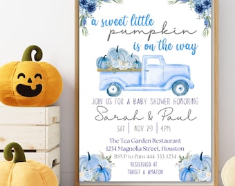 May include: A framed baby shower invitation with a light blue truck carrying pumpkins and the text "a sweet little pumpkin is on the way." The invitation is for Sarah & Paul, with details including the date, time, and location.