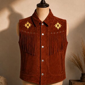 May include: A brown suede vest with a classic western design. The vest features fringe detailing, decorative yellow floral embroidery, and silver snap closures. The vest is displayed on a mannequin.