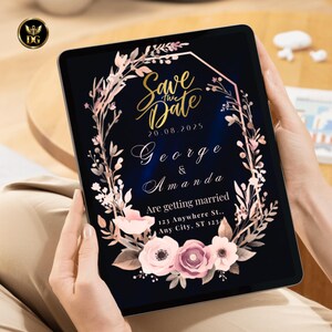Op de afbeelding: Een digitale tablet toont een huwelijksuitnodiging. De uitnodiging bevat de tekst "Save the Date" in gouden letters, de namen "George & Amanda" en de datum 20.08.2025. Een roze en witte bloemenkrans omringt de tekst.