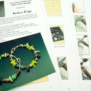 May include: A pair of handmade glass and river stone earrings. The earrings are made with polymer clay, glass beads, and wire. The earrings are a light green and yellow color. The earrings are approximately 6 inches long.