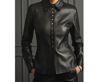 May include: Black leather shirt with a classic collar and long sleeves. The shirt features a button-up front with silver-toned buttons and a tailored fit. The model is wearing black pants, creating a monochromatic look.
