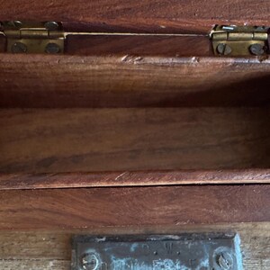 May include: A rustic wooden sign with the text "Welcome to our home" in white lettering. The sign features a distressed finish and a simple, inviting design, perfect for entryway decor.