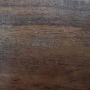 May include: A white ceramic mug with a black handle and the text "But first, coffee" in a handwritten style. The mug is on a white surface. The mug is likely for hot beverages.