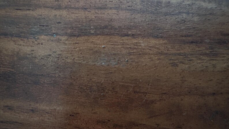 May include: A white ceramic mug with a black handle and the text "But first, coffee" in a handwritten style. The mug is on a white surface. The mug is likely for hot beverages.