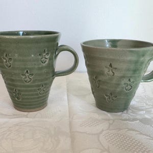 Unique hand thrown pair pottery mugs - marked Pv or Ad pale green/berries/floral
