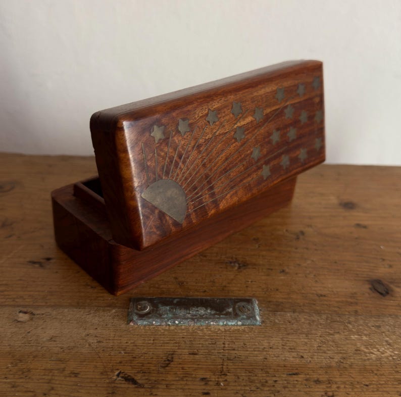 May include: A set of three ceramic mugs with a speckled, matte finish. The mugs are in shades of cream, light gray, and dark gray. Each mug has a simple, minimalist design and a rounded handle.