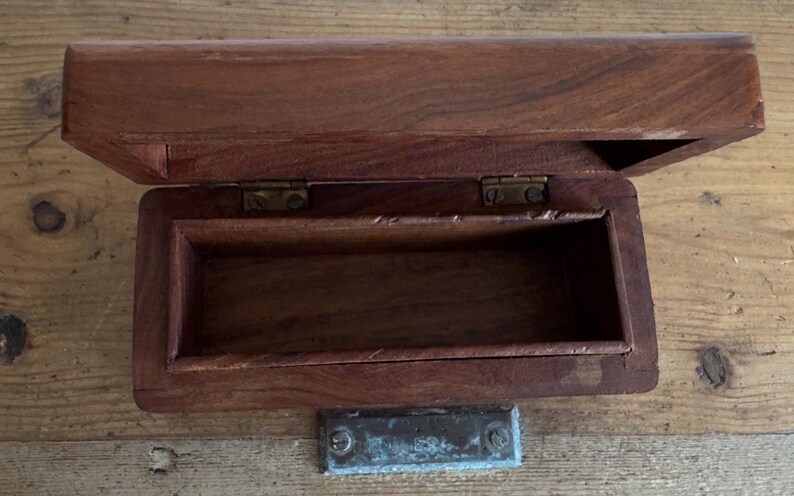 May include: A handmade, wooden serving tray with a natural finish. The tray features a rectangular shape with raised edges and integrated handles. The wood grain is visible, showcasing the tray's craftsmanship. Dimensions are approximately 18 inches long, 12 inches wide, and 2 inches high.