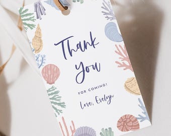 May include: A white gift tag with a brown leather string, featuring a seashell and coral border. The tag reads "Thank You" in navy blue script, with "For Coming! Love, Evelyn" below.