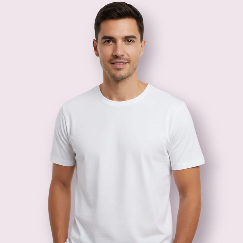 May include: A white crew neck t-shirt. The short-sleeved shirt is made of a soft material. The person wearing the shirt is smiling.