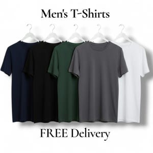 May include: Five plain T-shirts in navy, black, dark green, grey, and white, displayed on white hangers. The image features the text "Men's T-Shirts" above and "FREE Delivery" below, promoting a clothing range.