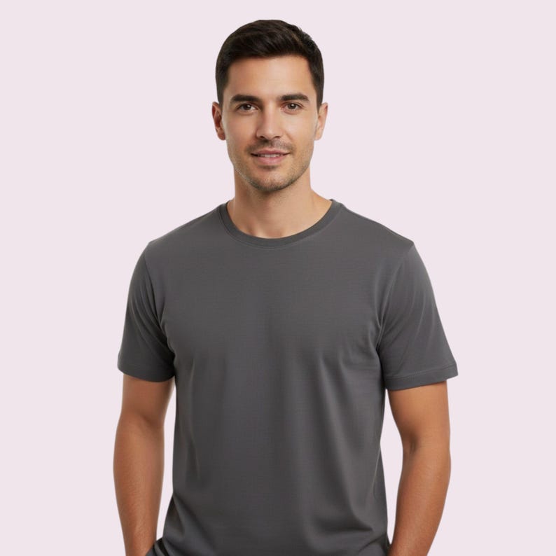 May include: A charcoal gray crew neck t-shirt. The short-sleeved shirt is made of a soft material and has a classic, simple design. The shirt is a versatile wardrobe staple.