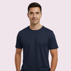 May include: A navy blue crew neck t-shirt. The short-sleeved shirt is made of a soft material. The person is wearing the shirt.