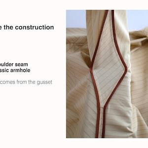 May include: A beige pinstriped garment featuring a diamond-shaped gusset with brown piping. Text on the left reads: Inside the construction, No shoulder seam, No classic armhole, Shape comes from the gusset. The design lacks traditional seams.