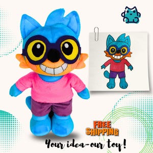 May include: A plush toy featuring a blue creature with large yellow-rimmed glasses, a wide white grin, a pink shirt, and purple shorts. Next to the plush is a paper drawing of the same character, clipped with a metal paperclip, showing the design.