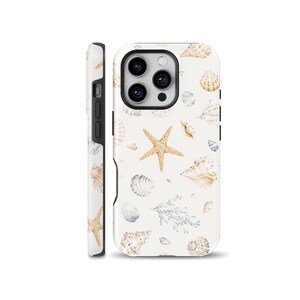 May include: A white smartphone case featuring a repeating pattern of tan starfish, various beige and grey seashells, and delicate grey coral branches. The design covers the back and side of the case, showcasing a detailed, light-coloured marine theme.