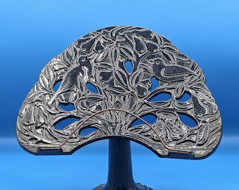 Vintage black cast iron book stand features an intricate "Partridge in a Pear Tree" design