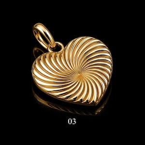 May include: A gold-toned heart-shaped pendant featuring a textured surface with radiating spiral grooves that originate from the centre. The pendant includes a polished circular bail at the top for attachment and is marked with the number 03.