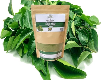 May include: A brown paper bag of curry leaves powder with a green label, surrounded by fresh green curry leaves. The label reads "Curry leaves (Murraya koenigii) Powder". The bag is sealed and ready for use.