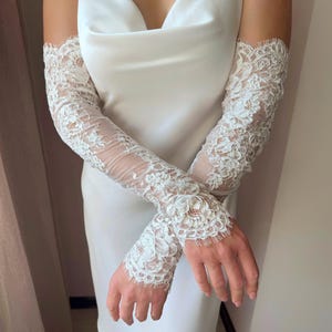 Elegant fingerless lace bridal gloves styled with modern slip wedding dress
