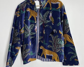 May include: A navy blue jacket with a vibrant jungle print featuring leopards, parrots, and toucans amidst palm trees. The jacket has a striped lining and a zip-up front. The overall design is a bold and colorful statement piece.