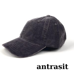 May include: A dark gray corduroy baseball cap with a curved brim. The cap has a six-panel design and a small button on top. The word "antrasit" is printed at the bottom of the image.