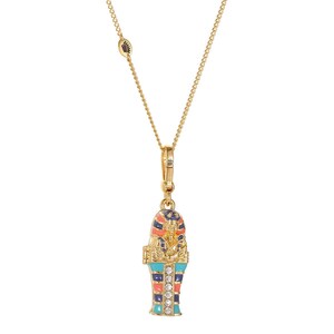 May include: Gold-toned necklace with a pendant shaped like an Egyptian sarcophagus. The pendant features colorful enamel details in blue, orange, and navy, accented with clear crystals. The necklace has a delicate chain and a lobster clasp.