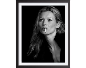 May include: Black and white framed print featuring a woman with long blonde hair, smoking a cigarette. The portrait is a close-up, with the subject's face and upper body visible against a dark background. The image is a classic, timeless piece.